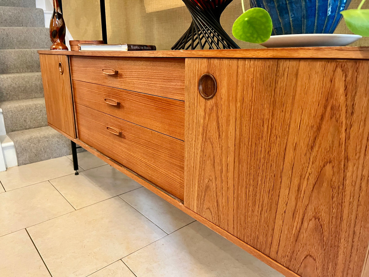 Restored mid-century modern wooden Avalon and hutch with a black metal frame, featuring a top cabinet-and-shelf section and a lower drawer-and-door cabinet section.