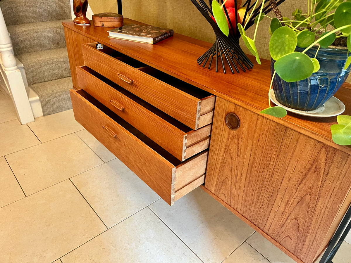 Restored mid-century modern wooden Avalon and hutch with a black metal frame, featuring a top cabinet-and-shelf section and a lower drawer-and-door cabinet section.
