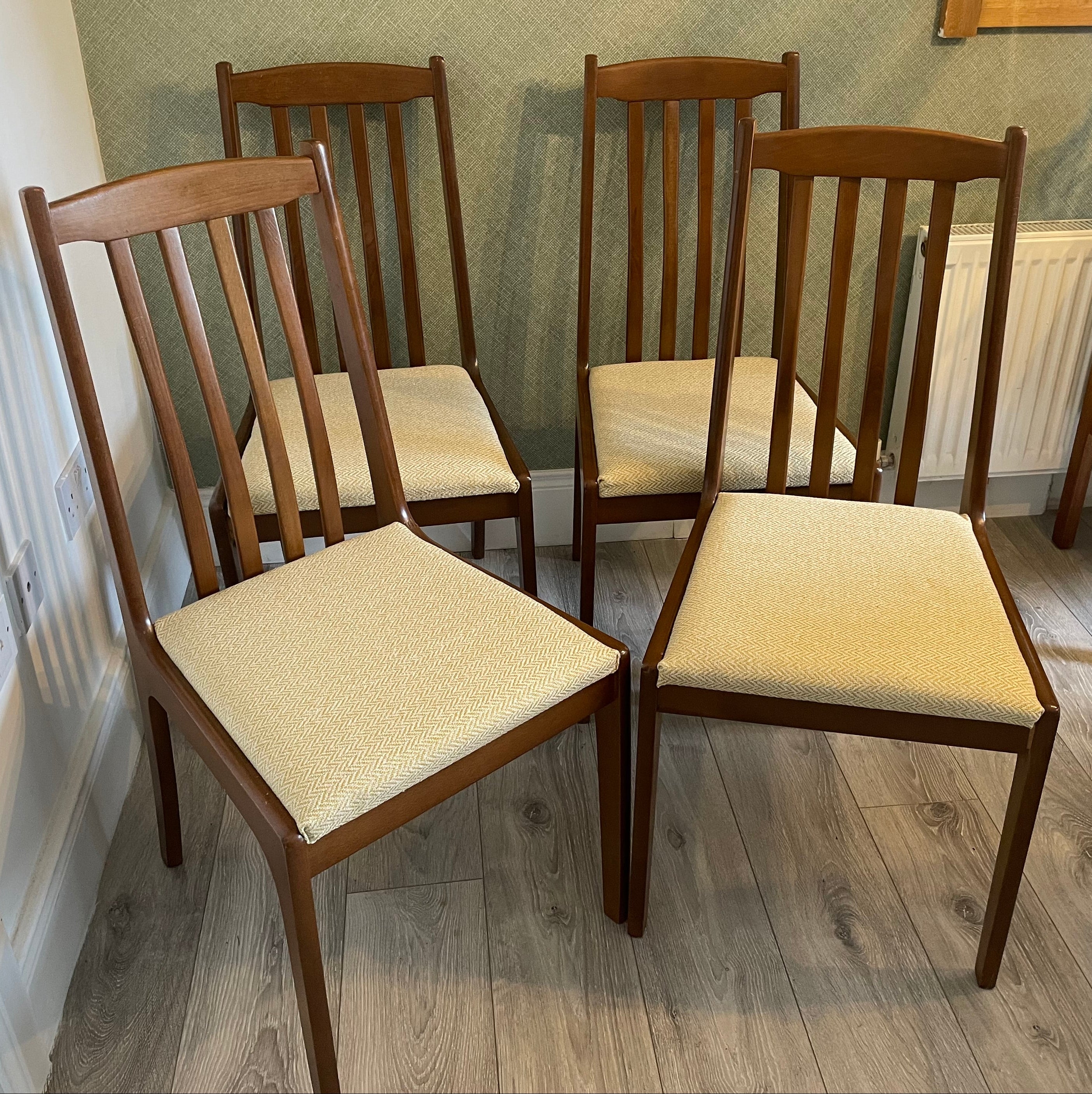 Four re-upholstered dining chairs covered in a pale lemon fabric by Grace & Joy Furniture
