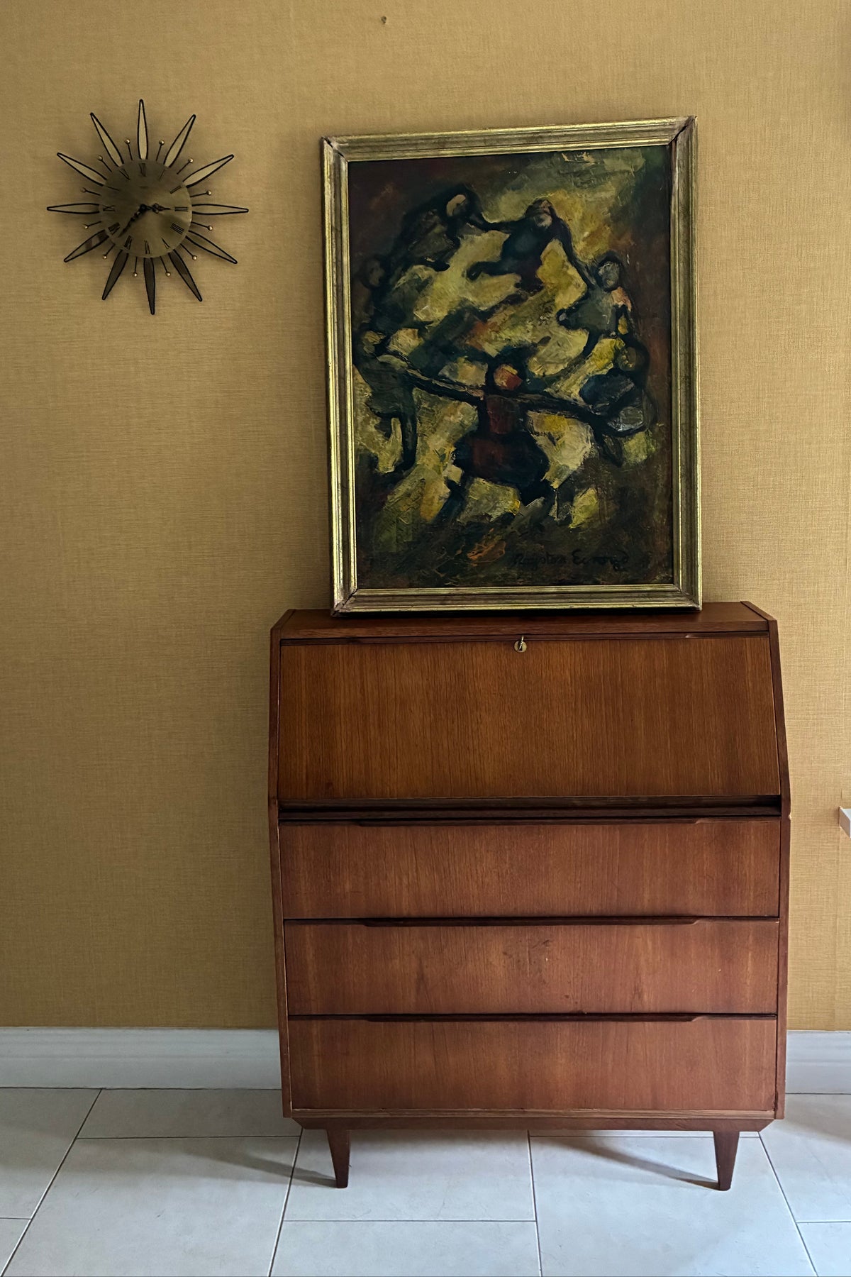A framed oil painting by Royston Ecroyd depicting several stylized figures in motion against a textured yellow, brown, and black background, enclosed in a gold-toned frame.