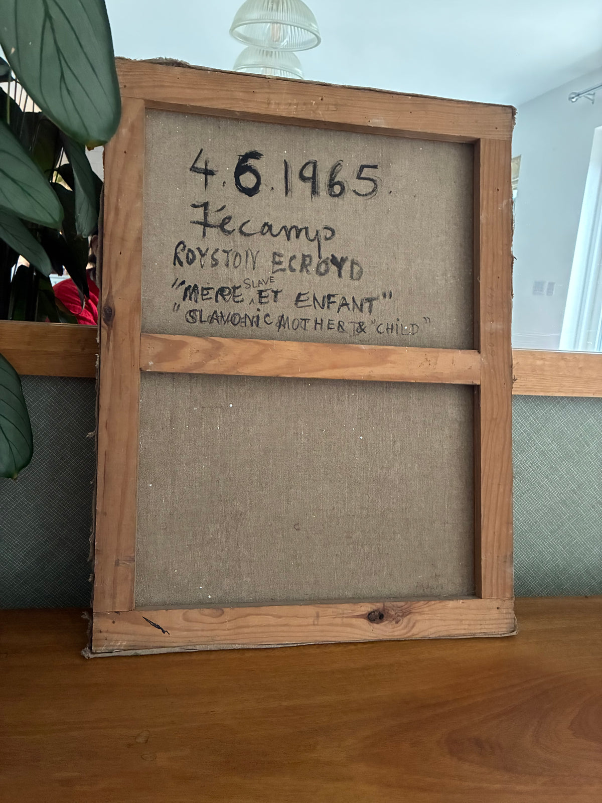 A vintage wooden framed canvas print showing the back side with handwritten text reading '4.6 1965
