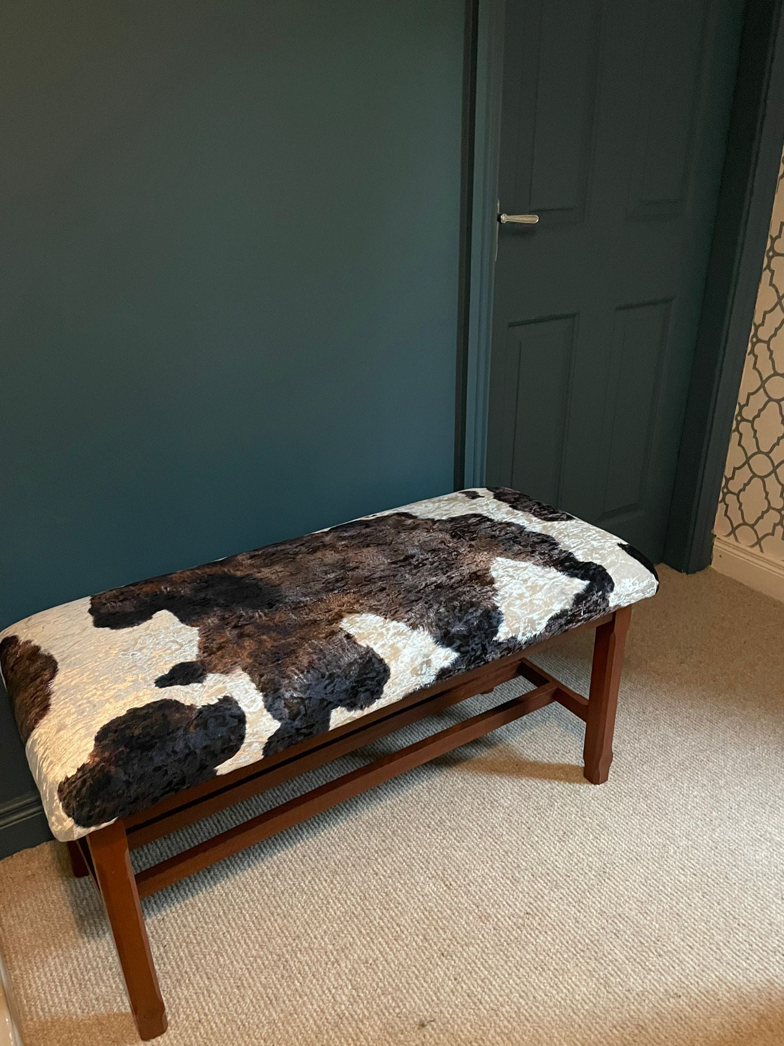 A Large Window Stool with Cowhide Style Upholstery.