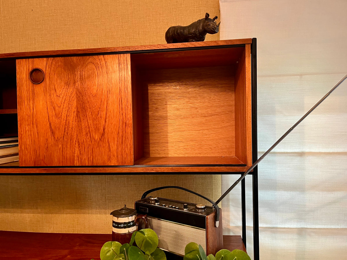 Restored mid-century modern wooden Avalon and hutch with a black metal frame, featuring a top cabinet-and-shelf section and a lower drawer-and-door cabinet section.