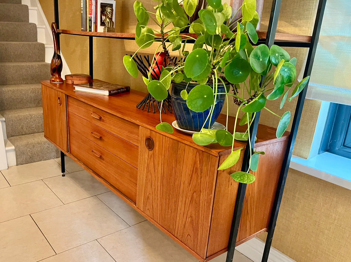 Restored mid-century modern wooden Avalon and hutch with a black metal frame, featuring a top cabinet-and-shelf section and a lower drawer-and-door cabinet section.
