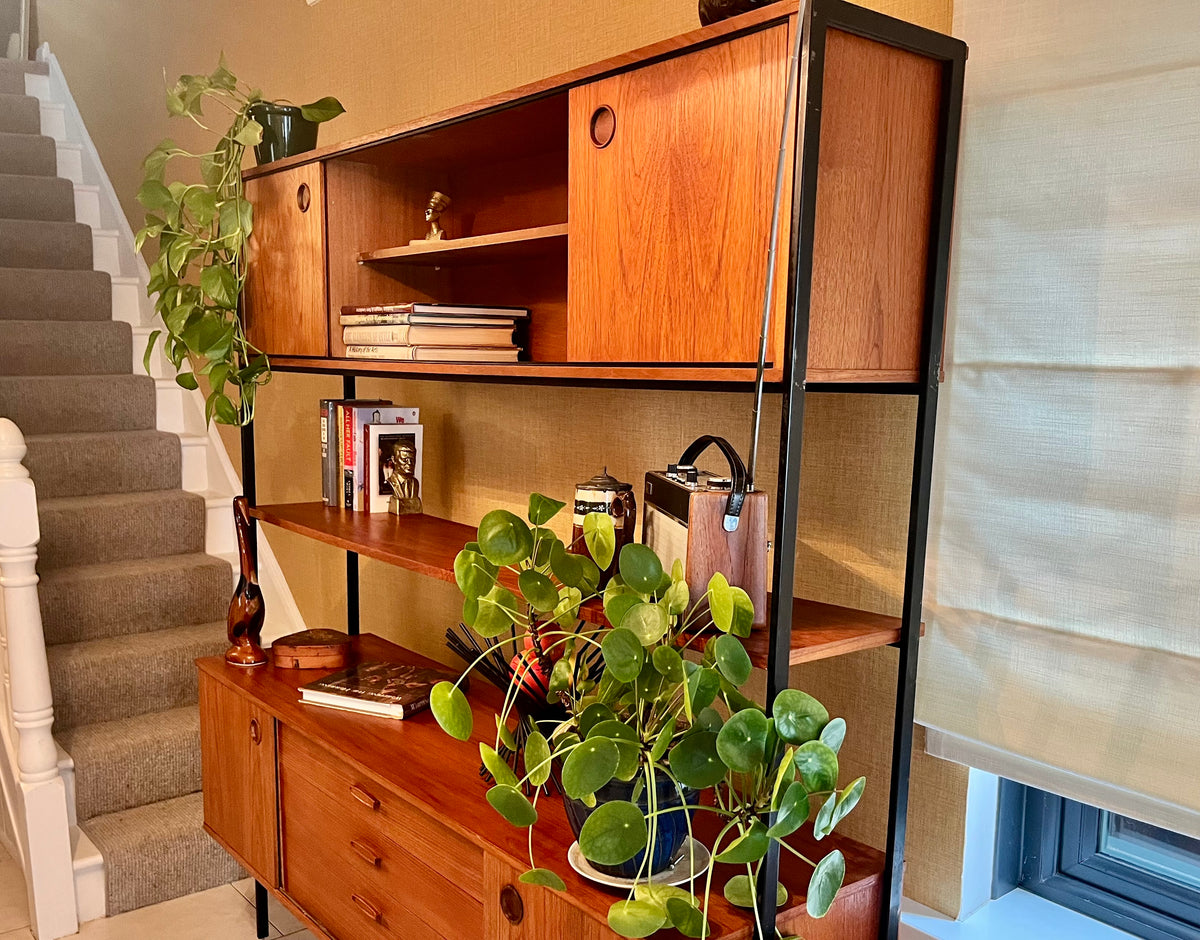 Restored mid-century modern wooden Avalon and hutch with a black metal frame, featuring a top cabinet-and-shelf section and a lower drawer-and-door cabinet section.