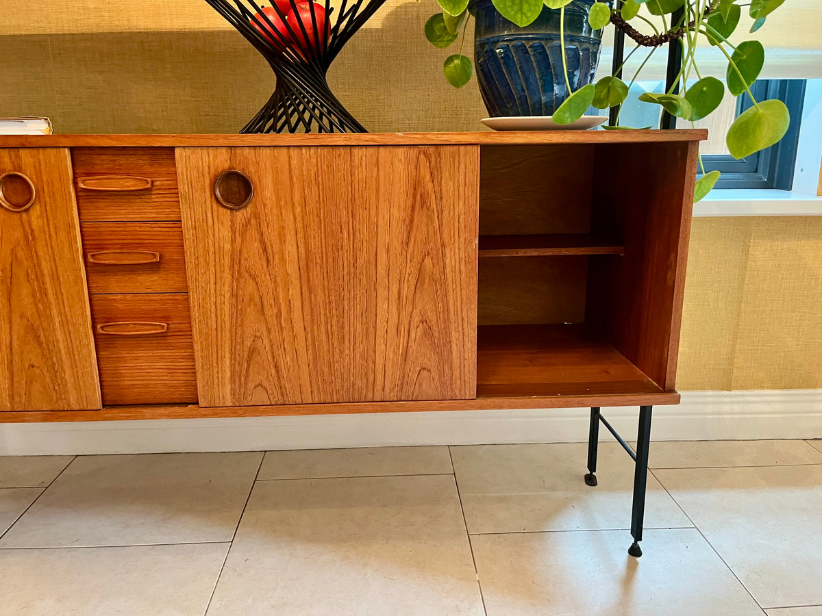 Restored mid-century modern wooden Avalon and hutch with a black metal frame, featuring a top cabinet-and-shelf section and a lower drawer-and-door cabinet section.
