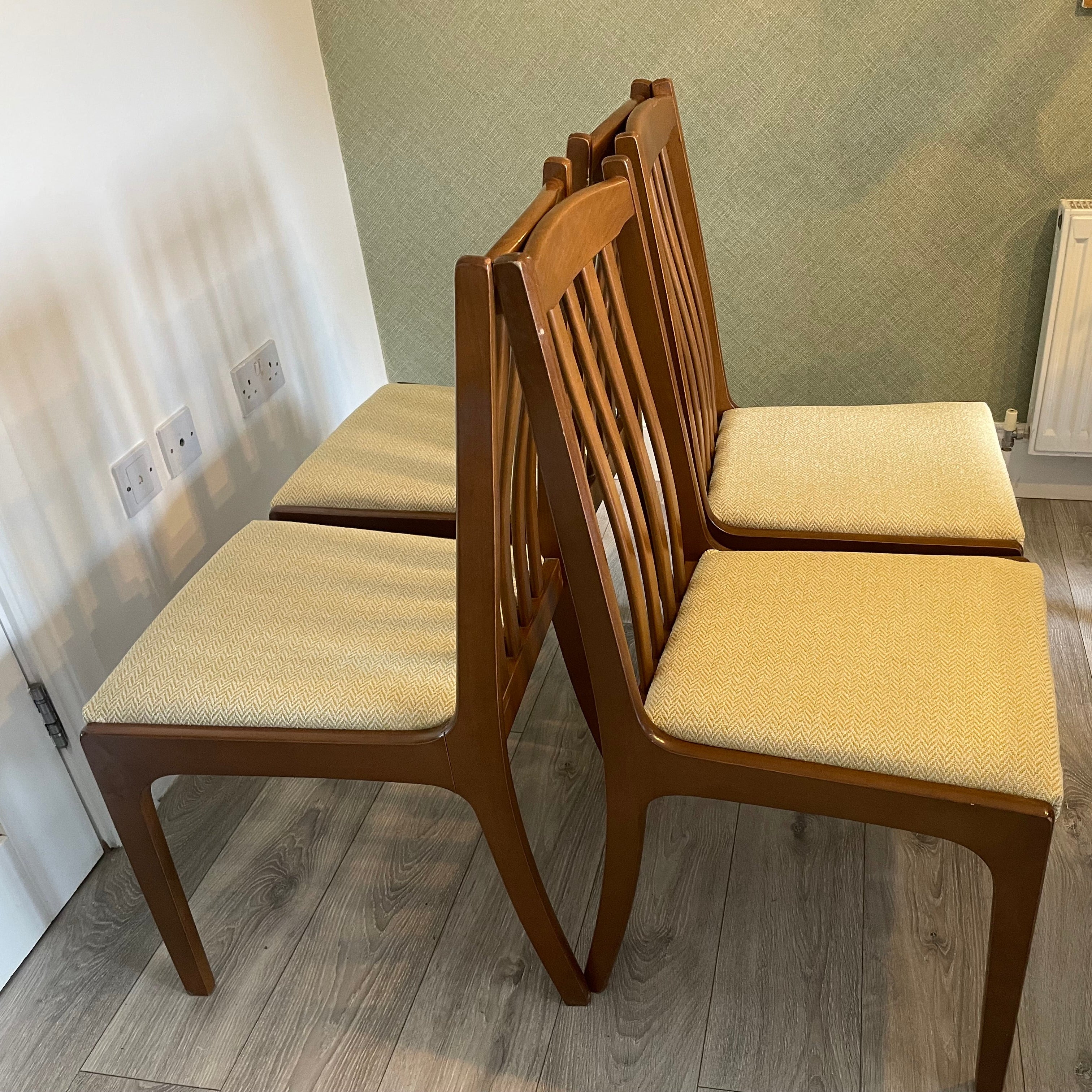 Four re-upholstered dining chairs covered in a pale lemon fabric by Grace & Joy Furniture
