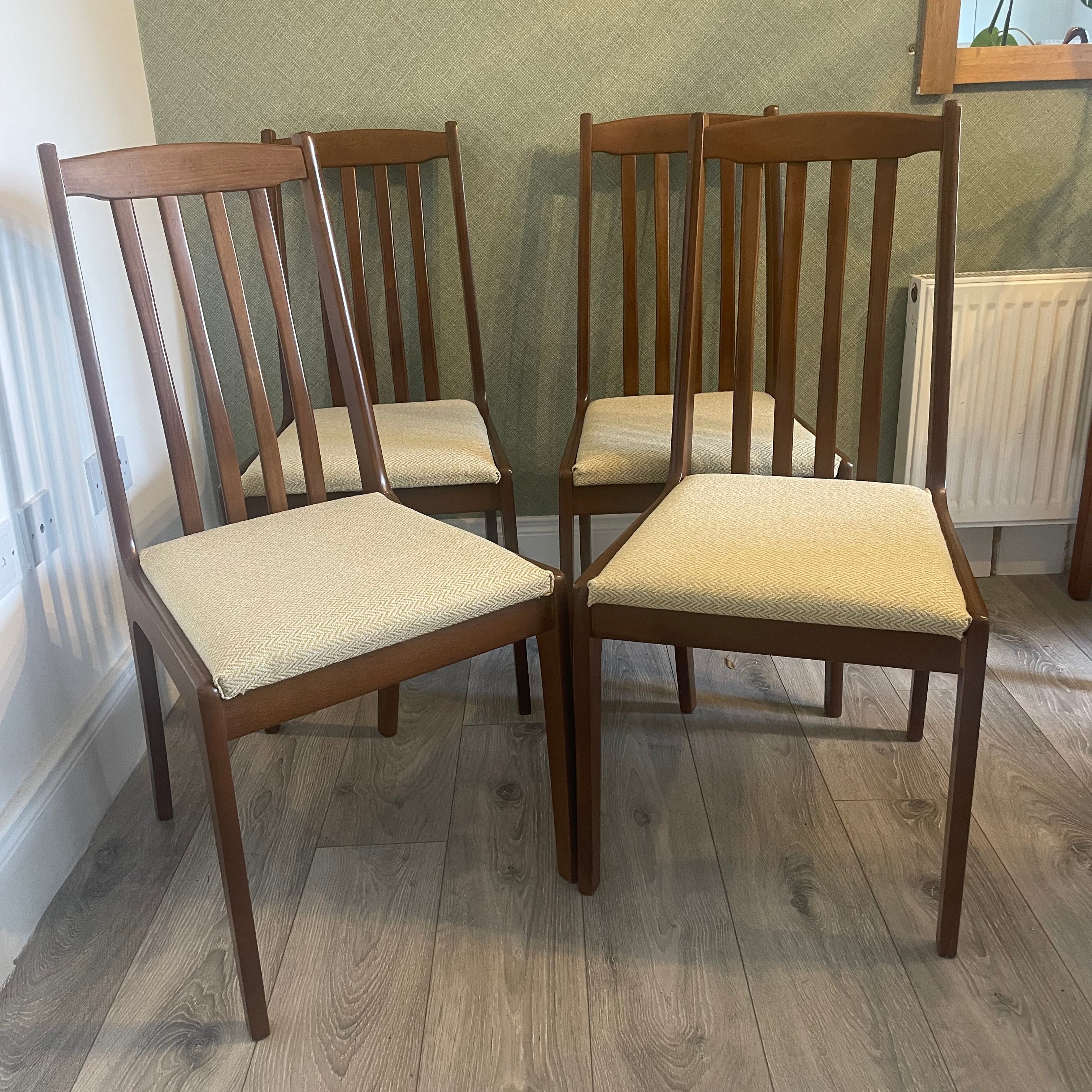 Four re-upholstered dining chairs covered in a pale lemon fabric by Grace & Joy Furniture