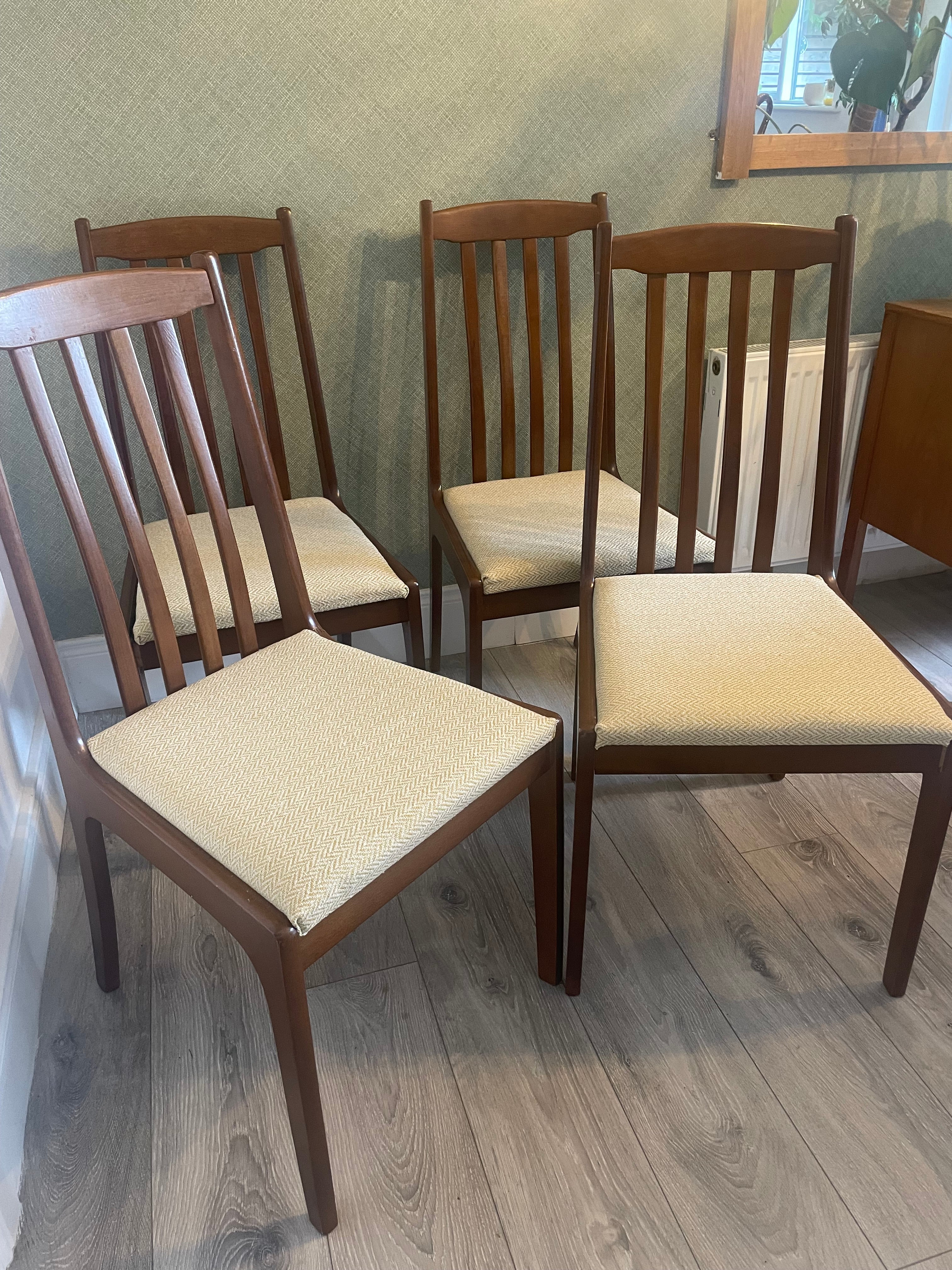 Four re-upholstered dining chairs covered in a pale lemon fabric by Grace & Joy Furniture