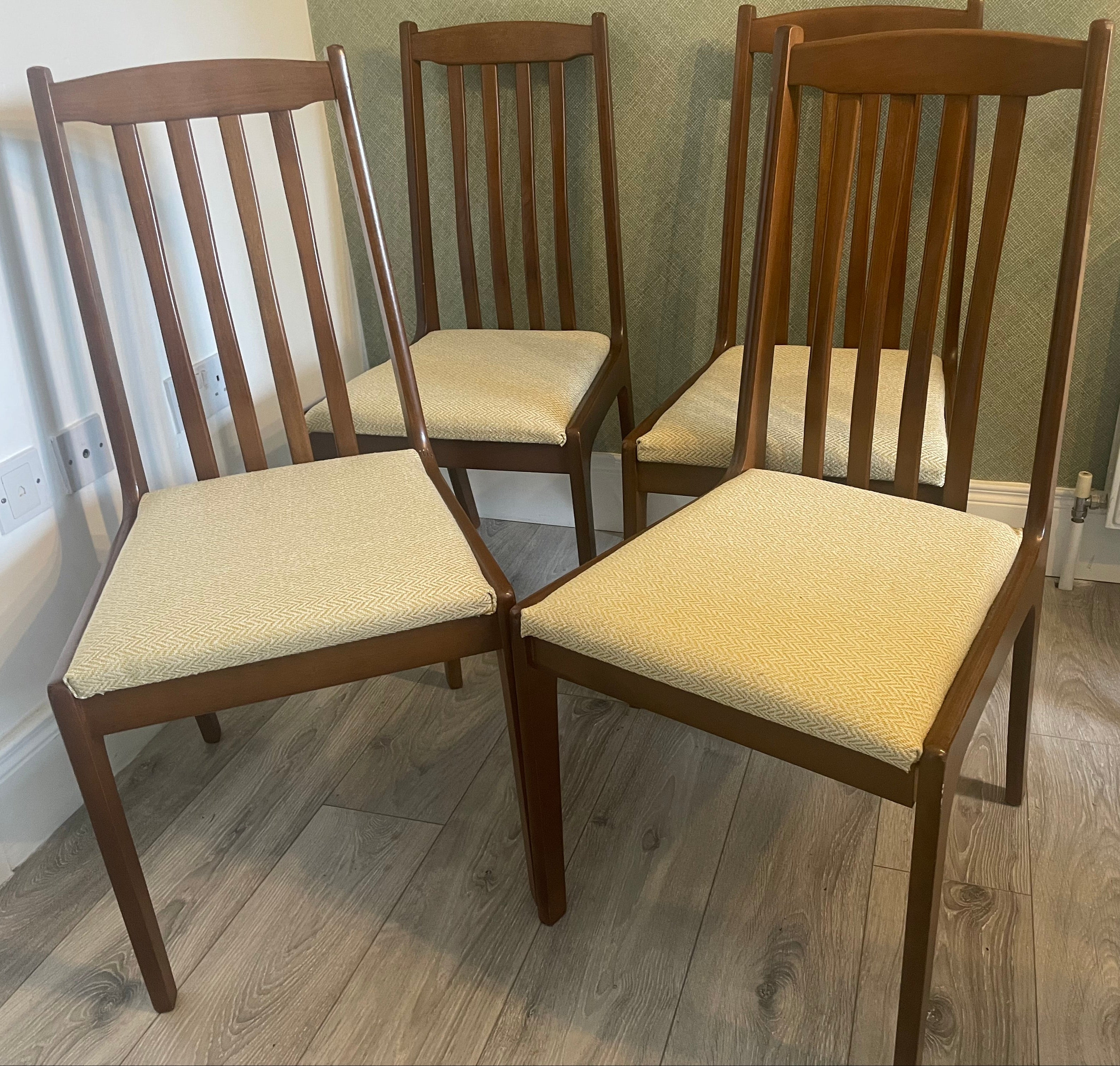 Four re-upholstered dining chairs covered in a pale lemon fabric by Grace & Joy Furniture