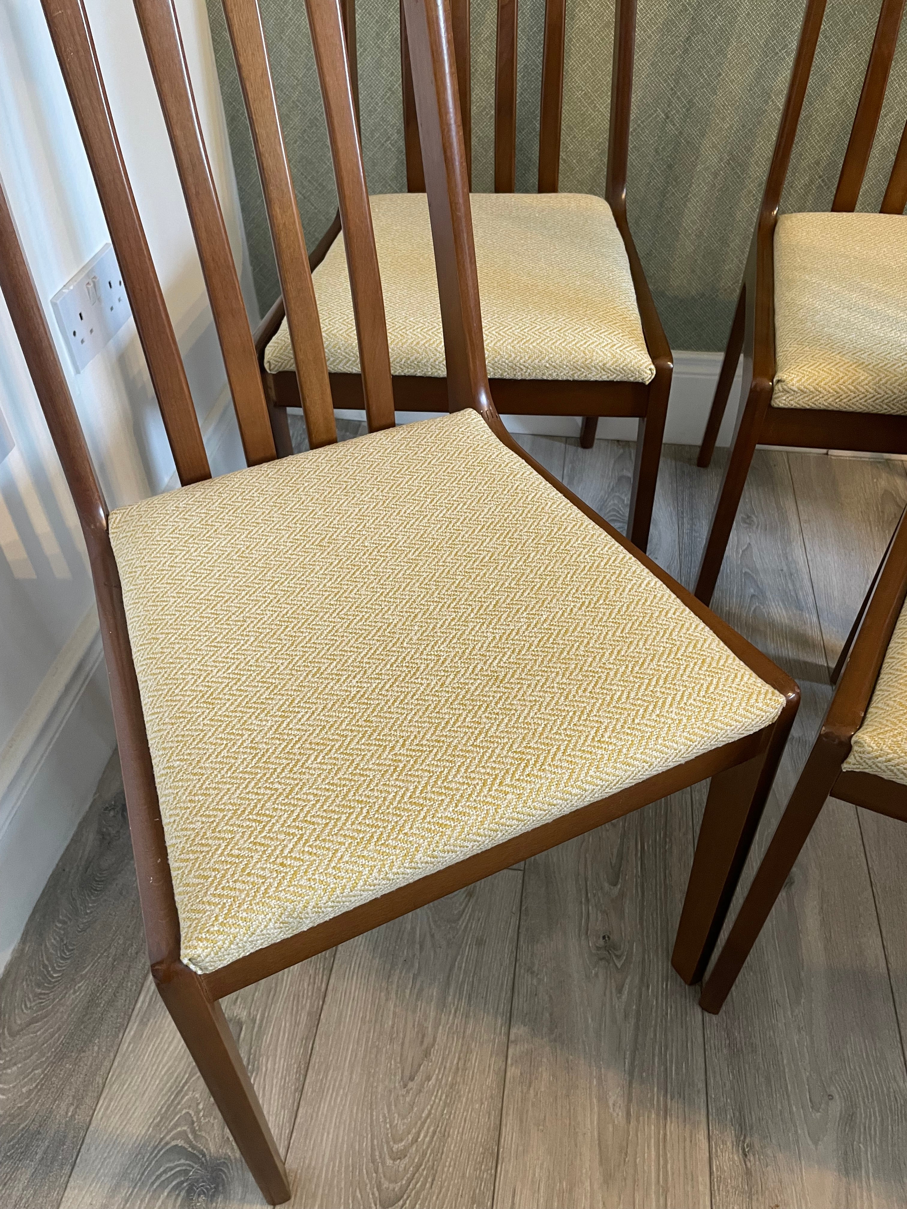 Four re-upholstered dining chairs covered in a pale lemon fabric by Grace & Joy Furniture