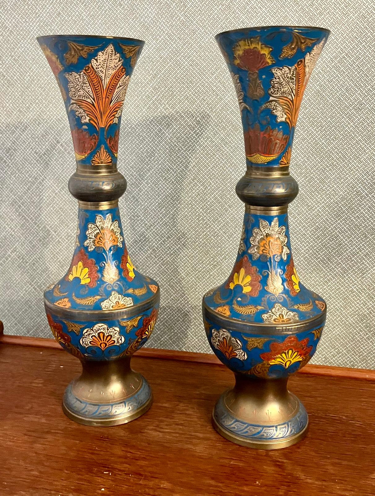 A pair of Indian enamelled brass vases
