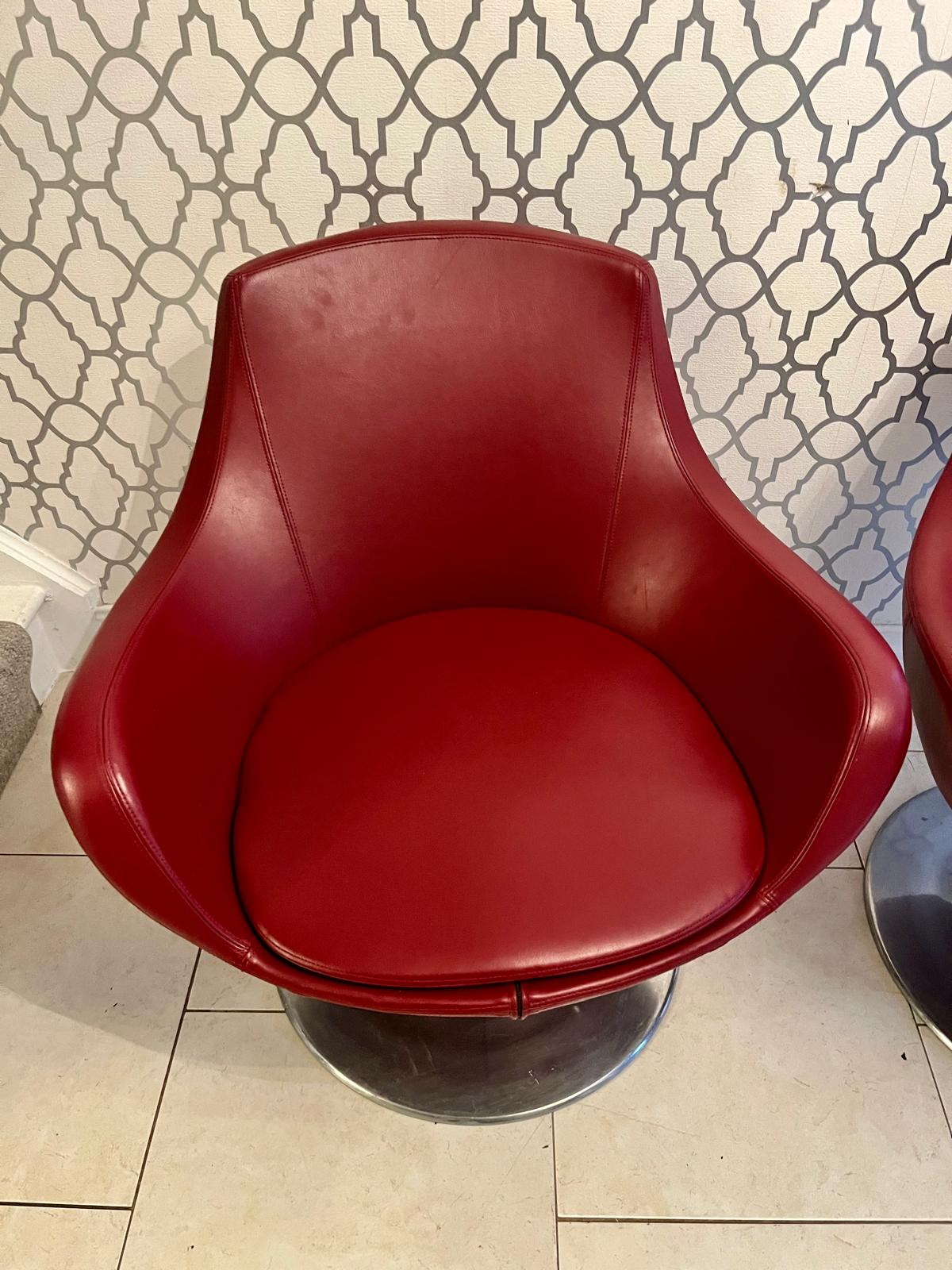 Pair of Red mid century swivel egg chairs