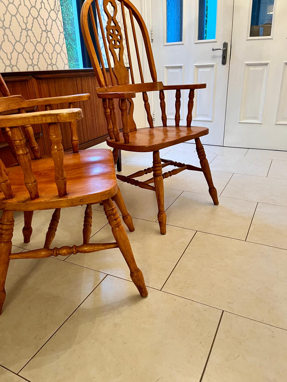 A pair of Windsor style armchairs